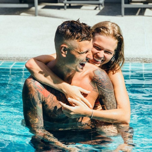 a man and woman hugging in a pool