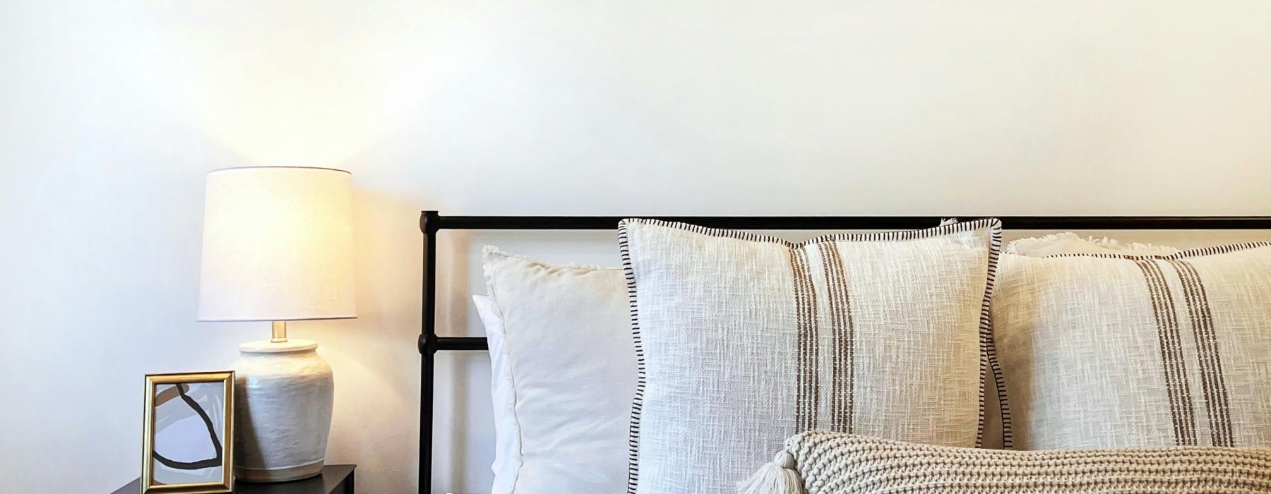 a bed with a lamp on the side