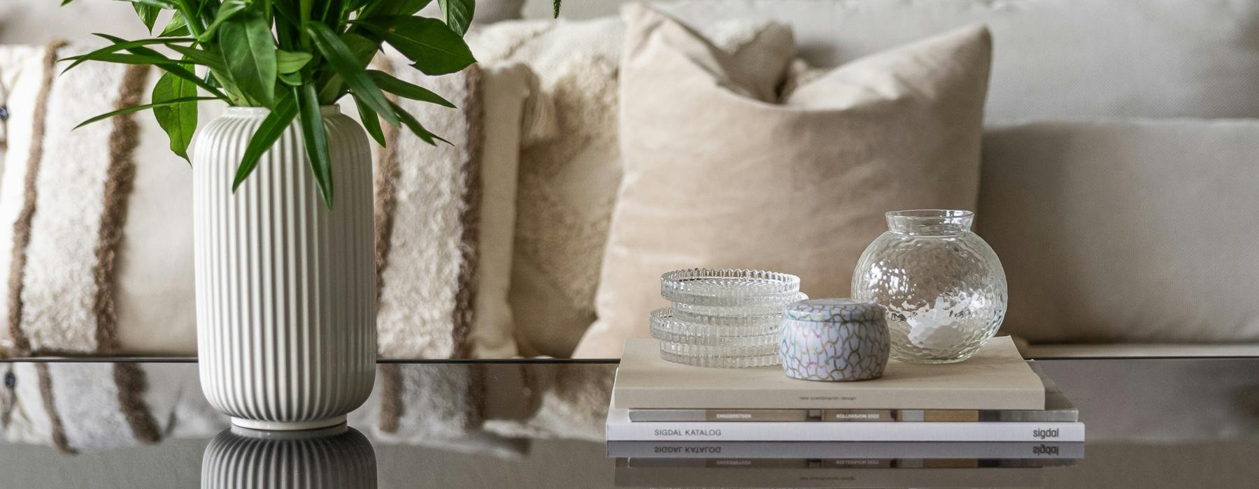 a table with a basket of fruit and a plant on it