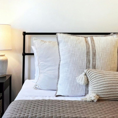 a bed with a lamp on the side