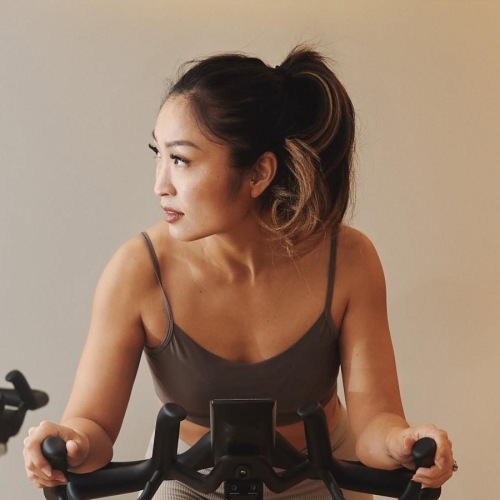 a woman riding a stationary bike